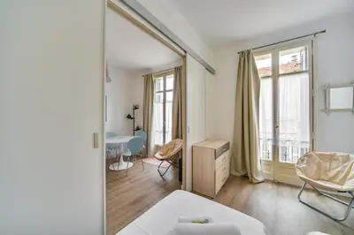 a white room with a bed and a window at IMMOGROOM- Close to the Palais des festivals- Wifi in Cannes
