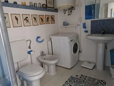 a bathroom with a toilet sink and a washing machine at Karol in Cannes