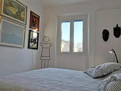 a bedroom with a bed and a window at Karol in Cannes