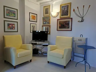 a waiting room with two chairs and a tv at Karol in Cannes