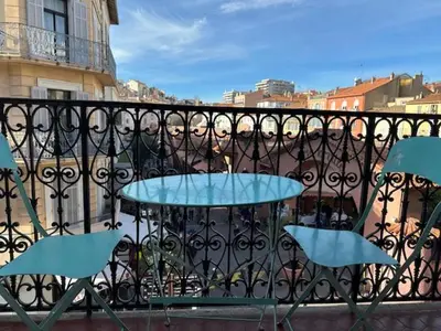 a table and chairs sitting on a balcony at Mark in Cannes