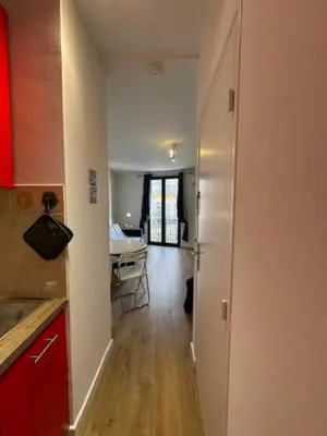a hallway leading to a kitchen with a table at Mark in Cannes