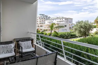 a balcony with chairs and a view of a building at Welcoming Apartment with parking - Croisette in Cannes