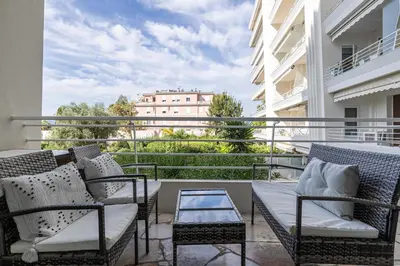 a balcony with chairs and a table on a balcony at Welcoming Apartment with parking - Croisette in Cannes