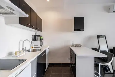 a kitchen with a sink and a counter top at Welcoming Apartment with parking - Croisette in Cannes