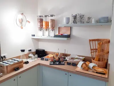 a kitchen with a counter with bread on it at Zenitude Hôtel-Résidences Le Cannet in Le Cannet