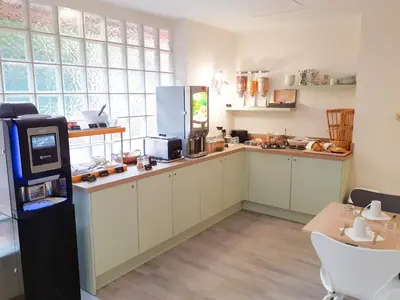 a kitchen with a counter with a vending machine at Zenitude Hôtel-Résidences Le Cannet in Le Cannet