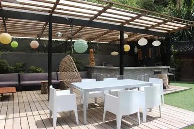 a white table and chairs under a pergola at Villa Le Ruisseau in Cannes