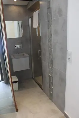 a bathroom with a shower and a sink at Villa Le Ruisseau in Cannes