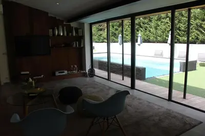 a living room with a view of a swimming pool at Villa Le Ruisseau in Cannes