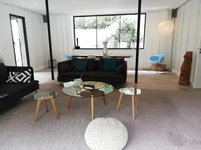 a living room with a couch and two tables at Villa Le Ruisseau in Cannes