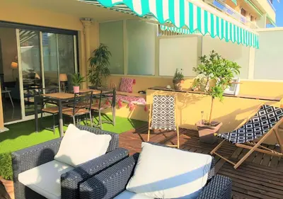 a living room with chairs and tables and a patio at Appartement Cosy Calme Central-Terrasse Proche Palais in Cannes