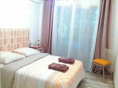 a bedroom with a bed with two towels on it at Residences Fleuries - behind Cannes Croisette Bvd in Cannes