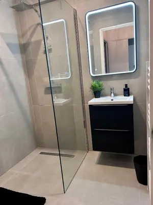 a bathroom with a shower and a sink and a mirror at Residences Fleuries - behind Cannes Croisette Bvd in Cannes