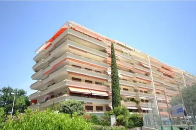 a large apartment building with a tree in front of it at Residences Fleuries - behind Cannes Croisette Bvd in Cannes