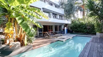 a house with a swimming pool in front of a house at Villa Roi Albert 2 in Cannes