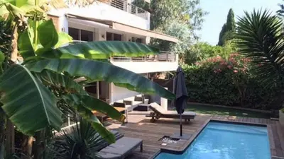 a house with a swimming pool next to a building at Villa Roi Albert 2 in Cannes