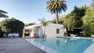 a large swimming pool in front of a house at Villa roi Albert 1 in Cannes