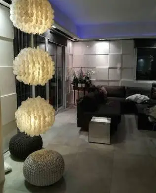 a living room with a couch and two chandeliers at Villa roi Albert 1 in Cannes