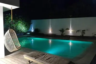 a bedroom with a bed and a desk and a television at Villa roi Albert 1 in Cannes