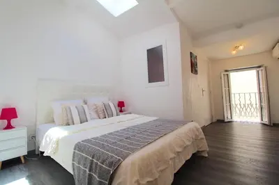 a white bedroom with a large bed and a window at Appartement moderne à Cannes, 45 m², proche des plages in Cannes