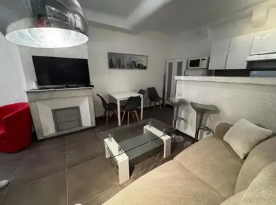 a living room with a couch and a table at Appartement moderne à Cannes, 45 m², proche des plages in Cannes
