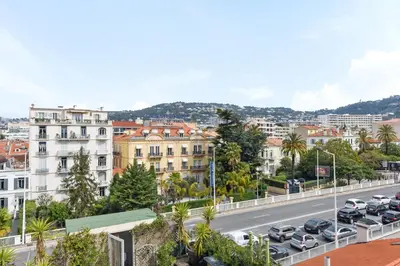 a city street with cars parked on the road at IMOOGROOM - Modern - City Center - AC - 9 min from the Palais in Cannes