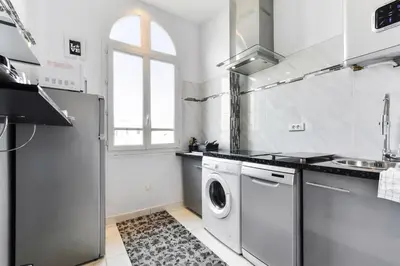 a kitchen with a washer and dryer in it at IMOOGROOM - Modern - City Center - AC - 9 min from the Palais in Cannes
