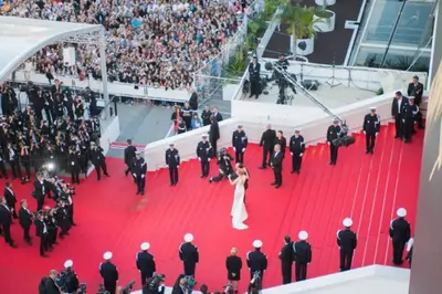 a bride and groom on the red carpet at a premiere at Grand Studio Carré d'Or - Les Méridiens in Cannes