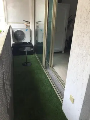 a room with a fan and a green floor at Grand Studio Carré d'Or - Les Méridiens in Cannes
