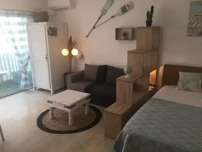 a living room with a bed and a couch at Grand Studio Carré d'Or - Les Méridiens in Cannes