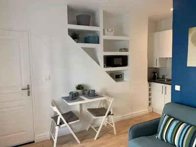 a small apartment with a desk and a staircase in a room at Azur Studios Cannes in Cannes