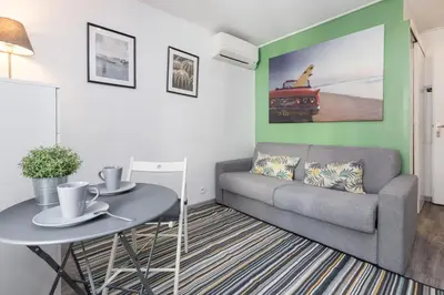 a living room with a couch and a table at Azur Studios Cannes in Cannes