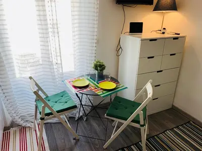 a small kitchen with a small table and two chairs at Azur Studios Cannes in Cannes