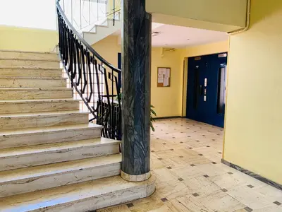 a staircase in a building with a blue door at Cannes Apartment 3 mins from the beach in Cannes