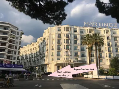 a large white building with a sign in front of it at Cannes Apartment 3 mins from the beach in Cannes