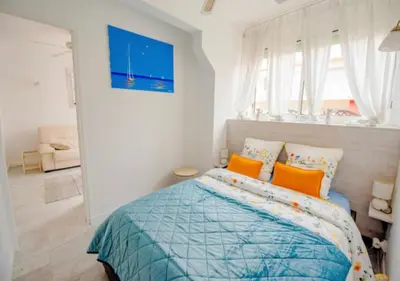 a bedroom with a bed with orange pillows at Cannes Apartment 3 mins from the beach in Cannes