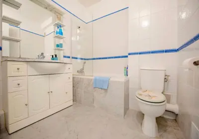 a bathroom with a toilet and a tub and a sink at Cannes Apartment 3 mins from the beach in Cannes