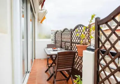a balcony with a table and chairs on it at Cannes Apartment 3 mins from the beach in Cannes