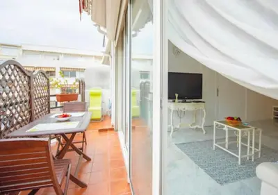 two images of a living room with a table and a television at Cannes Apartment 3 mins from the beach in Cannes