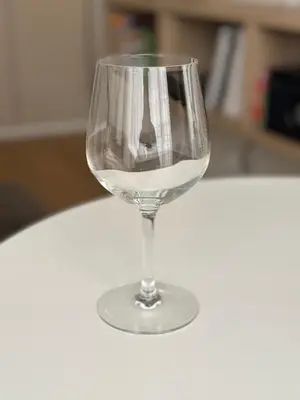 a glass of white wine sitting on a table at Studio Cosy Pradignac in Cannes
