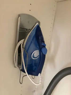 a blue iron is hanging on a wall at Studio Cosy Pradignac in Cannes