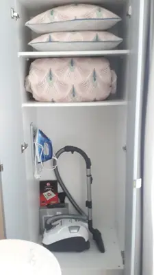 a room with a vacuum in a refrigerator at Studio Cosy Pradignac in Cannes