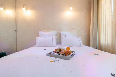 a bed with a tray with stuffed animals on it at Aby in Cannes