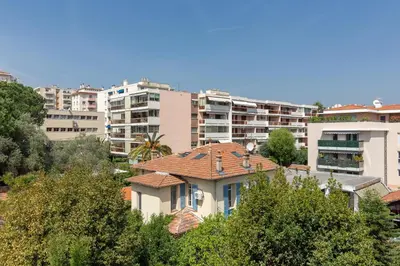 a house in front of some apartment buildings at Aby in Cannes