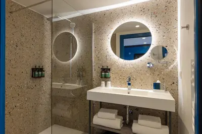 a bathroom with a sink and a mirror at Staybridge Suites - Cannes Centre by IHG in Cannes
