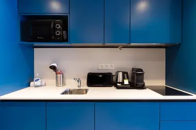 a kitchen counter with a sink and a microwave at Staybridge Suites - Cannes Centre by IHG in Cannes