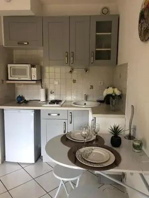 a kitchen with a table and two chairs in it at Cannes center in Cannes