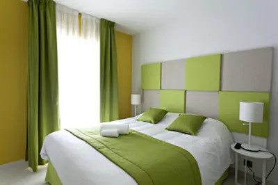 a green and white bedroom with a bed and a window at Arthur Properties - Montfleury in Cannes