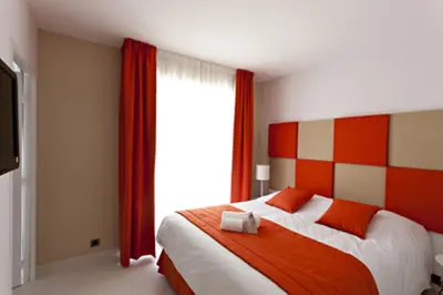 a bedroom with a bed and a large window at Arthur Properties - Montfleury in Cannes